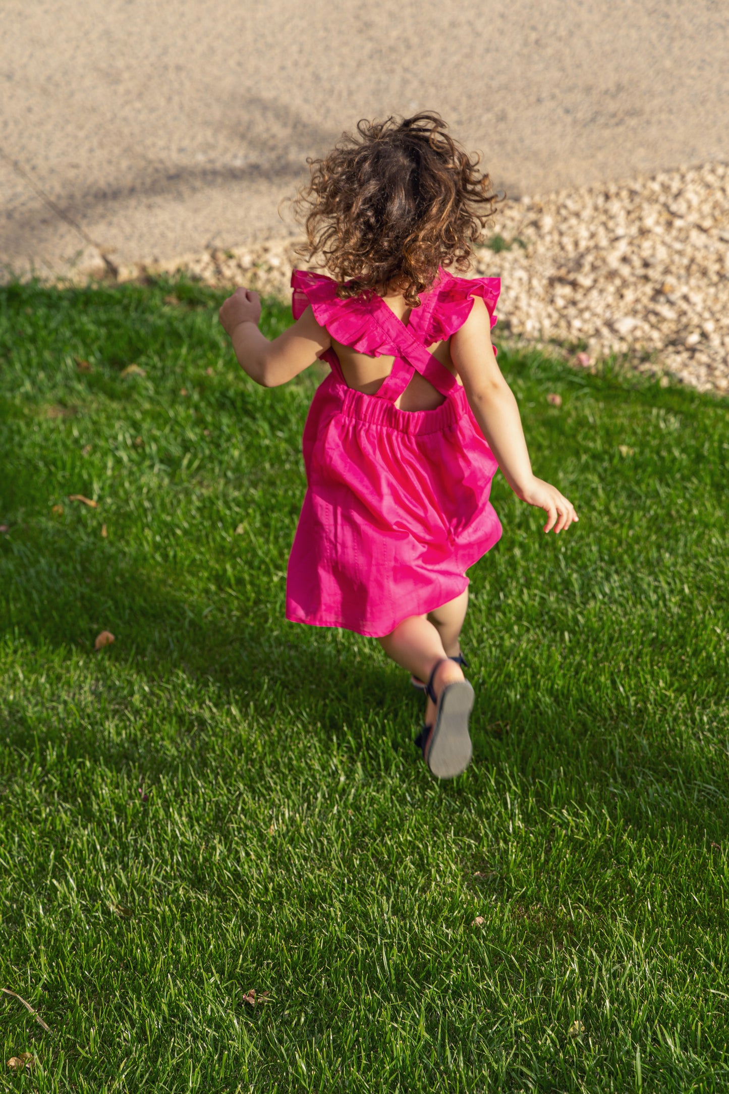 Bright pink ruffle dress with cross back